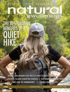 Natural Awakenings Chicago August 2022 cover with a woman overlooking a creek as she is hiking.